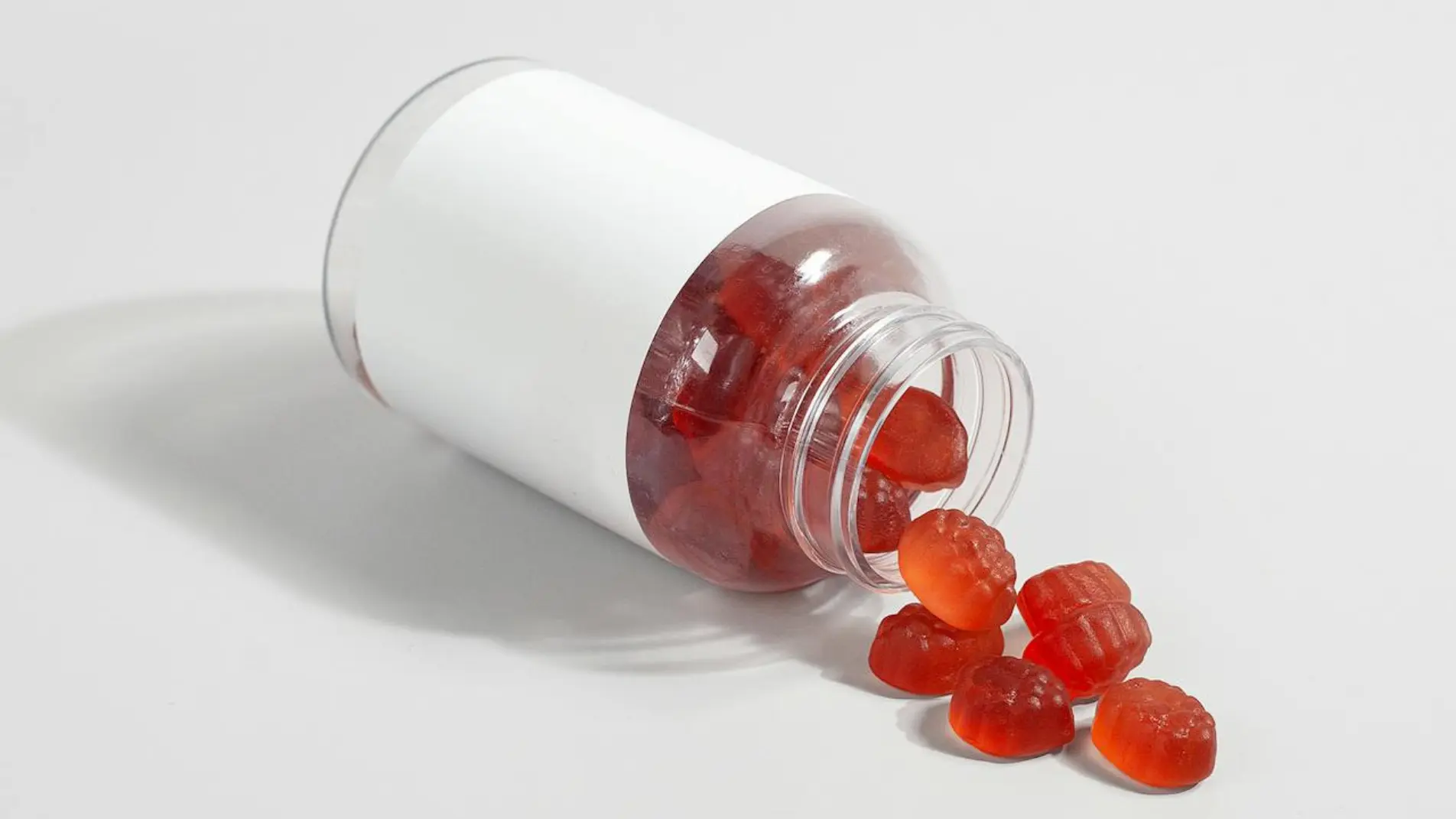 open bottle of Ashwagandha Gummies with some gummies spreaded outside